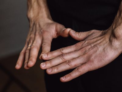 Close-up of hands in a meditative mudra position.